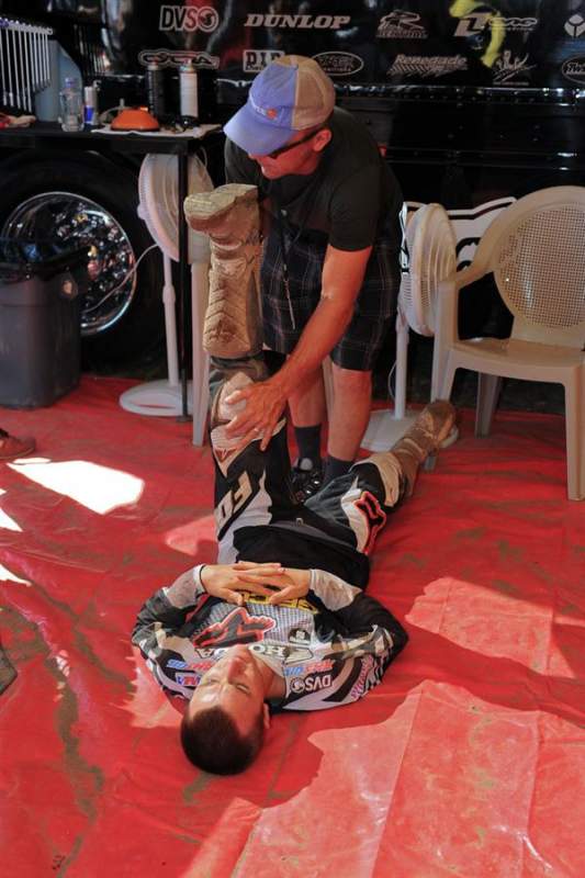 Eli Tomac getting stretched out by his dad, John. Tomac was strong in practice, posting the fifth-fastest time.