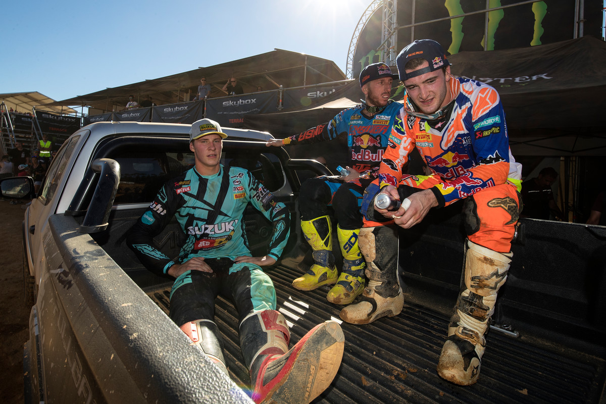 The top three (Jasikonis, left; Cairoli, center; and Herlings, right) catch a ride to the podium after the race.
