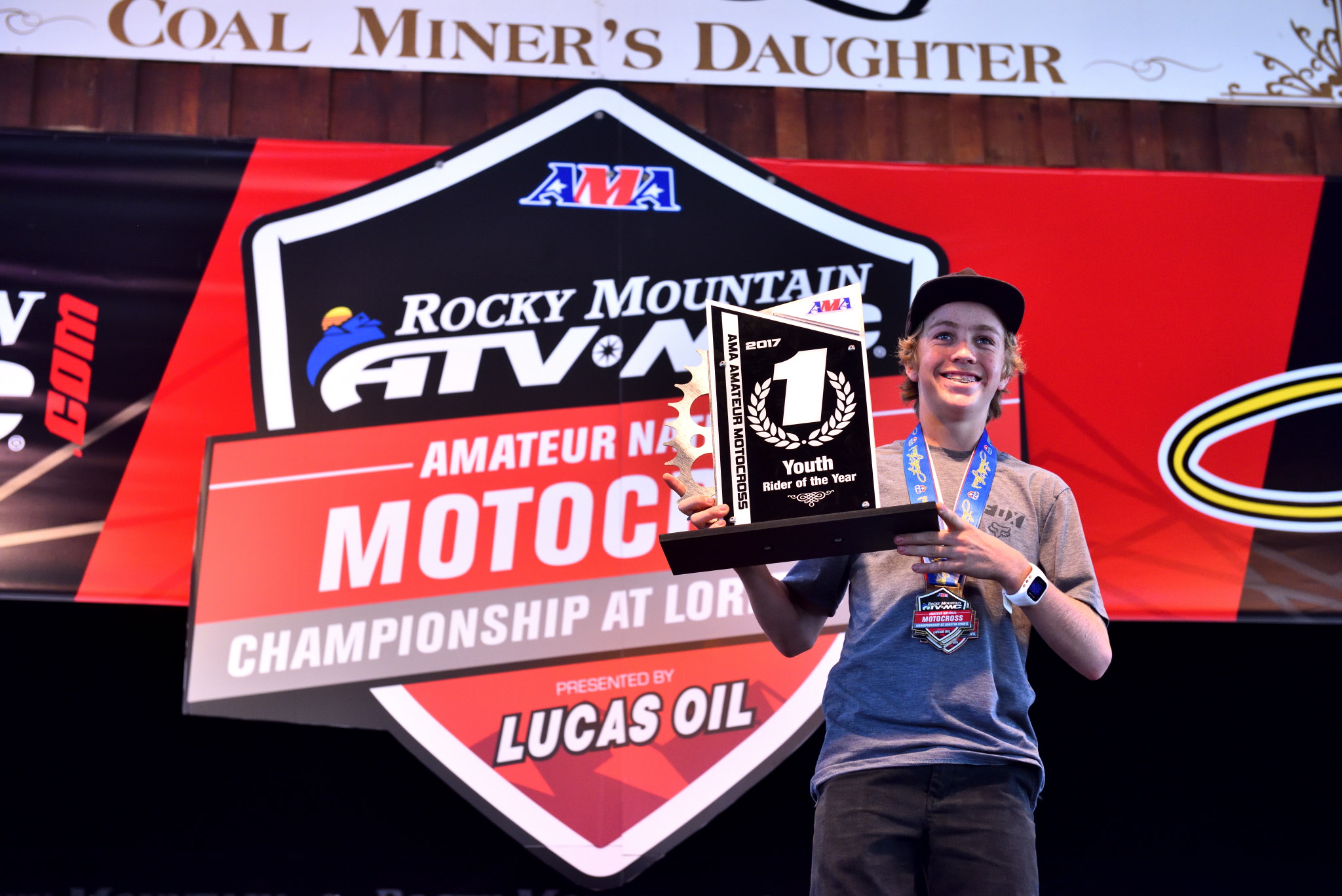 Masterpool with two Loretta's medals around his neck and a Youth Rider of the Year trophy in hand.