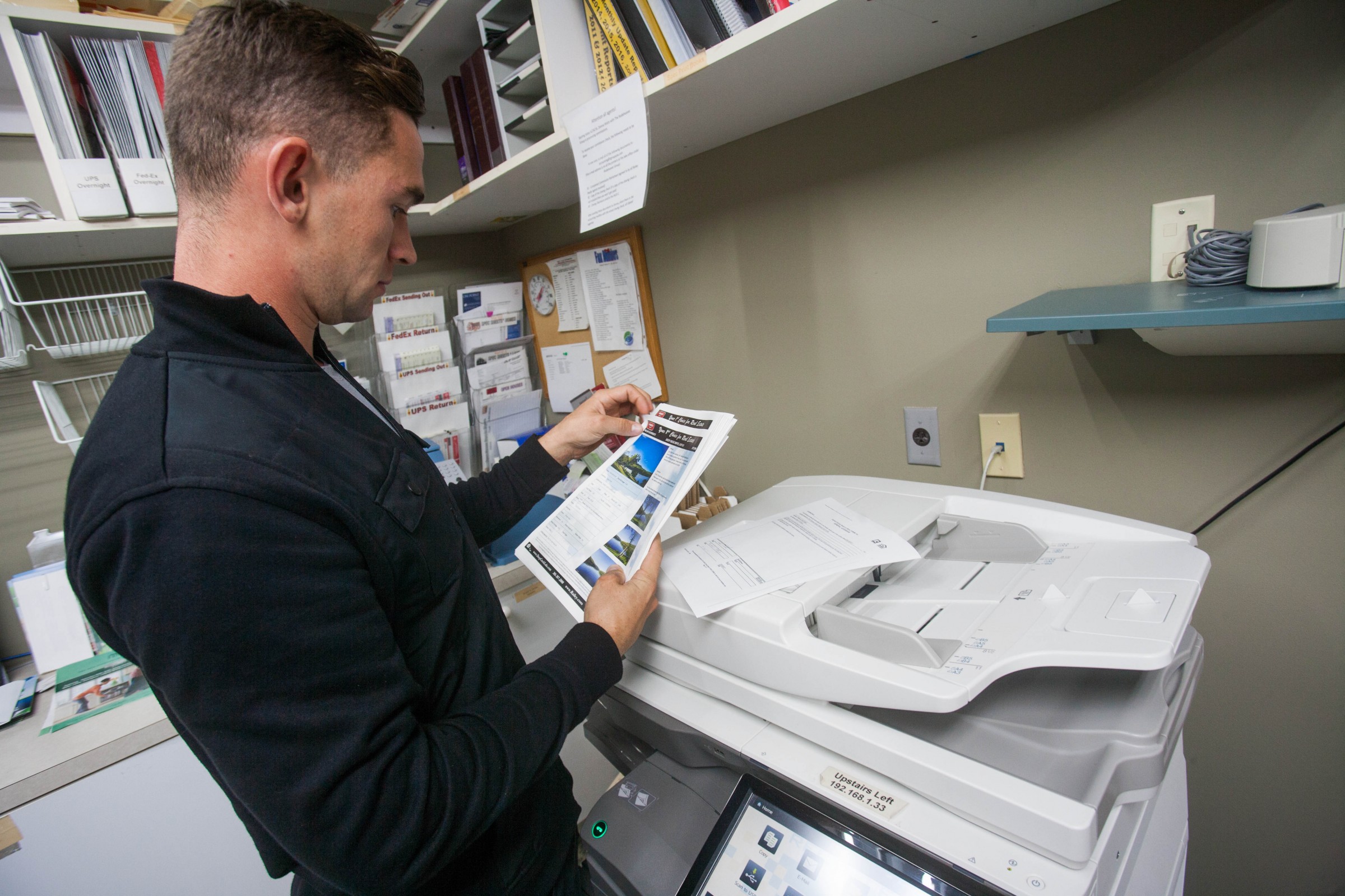 Printing off flyers at the Railey Realty office in McHenry, Maryland.