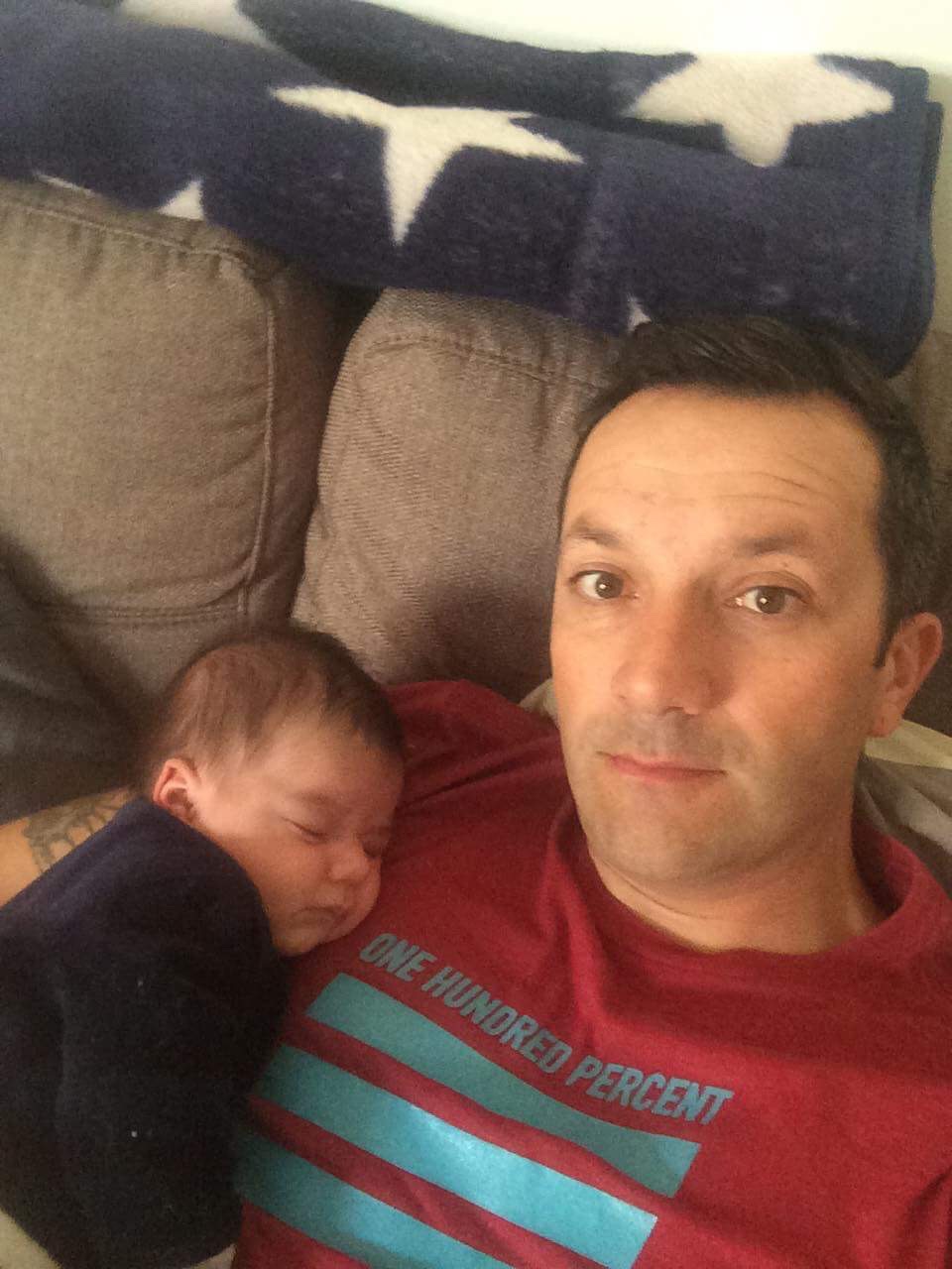 Eric and his newborn baby.