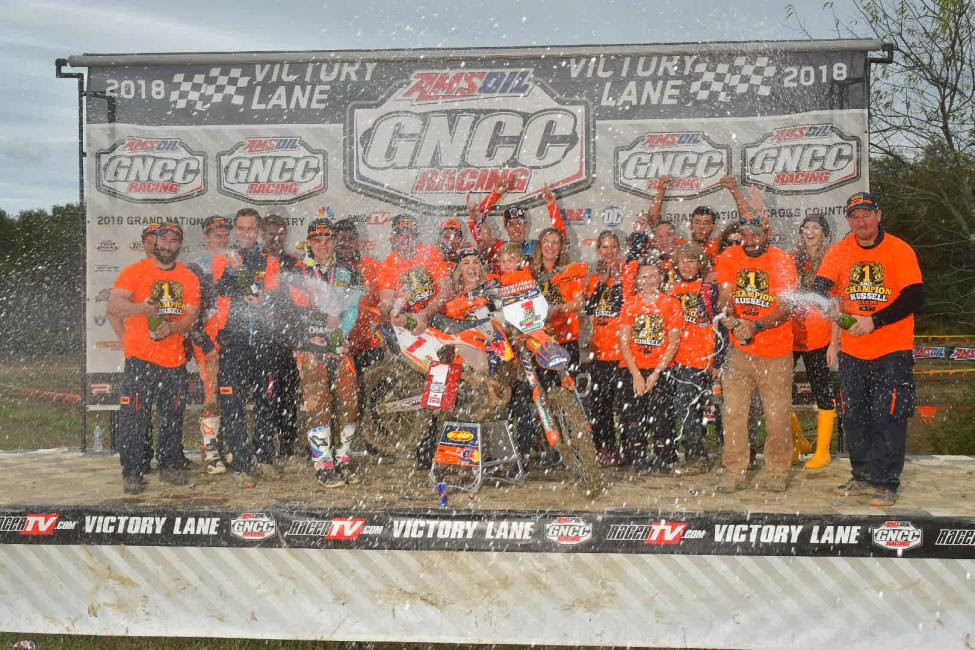 FMF/KTM Factory Racing celebrating Kailub Russell's Sixth-Consecutive GNCC National Championship with champagne showers.