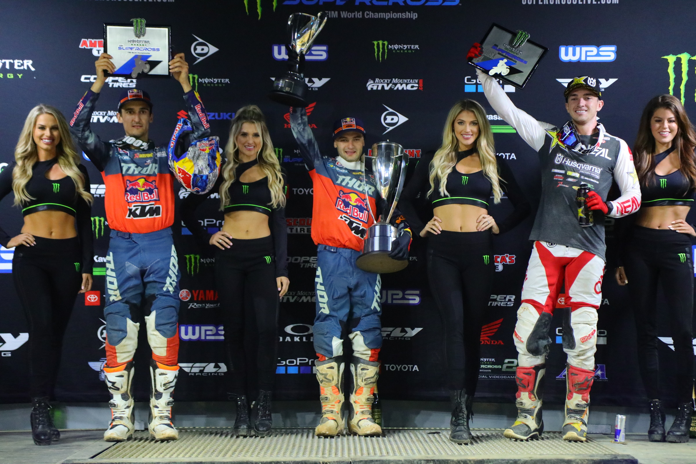 Two of the racers on this podium are truly happy with their finishing positions.