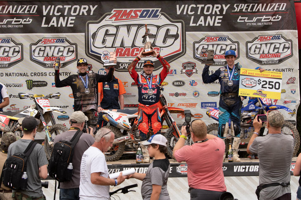 Kailub Russell (center), Ricky Russell (right), and Thad Duvall (left) rounded out the overall Parts Unlimited Black Sky GNCC podium.