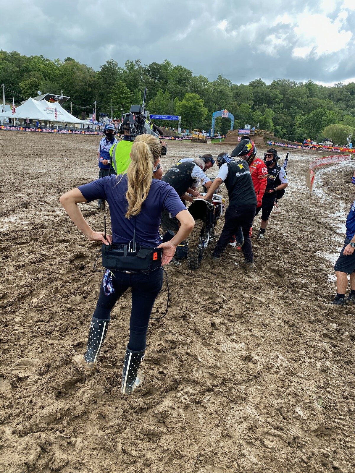 The Rockstar Energy Husqvarna team working on Zach Osborne's FC 450 as NBC pit report Will Christien watches.
