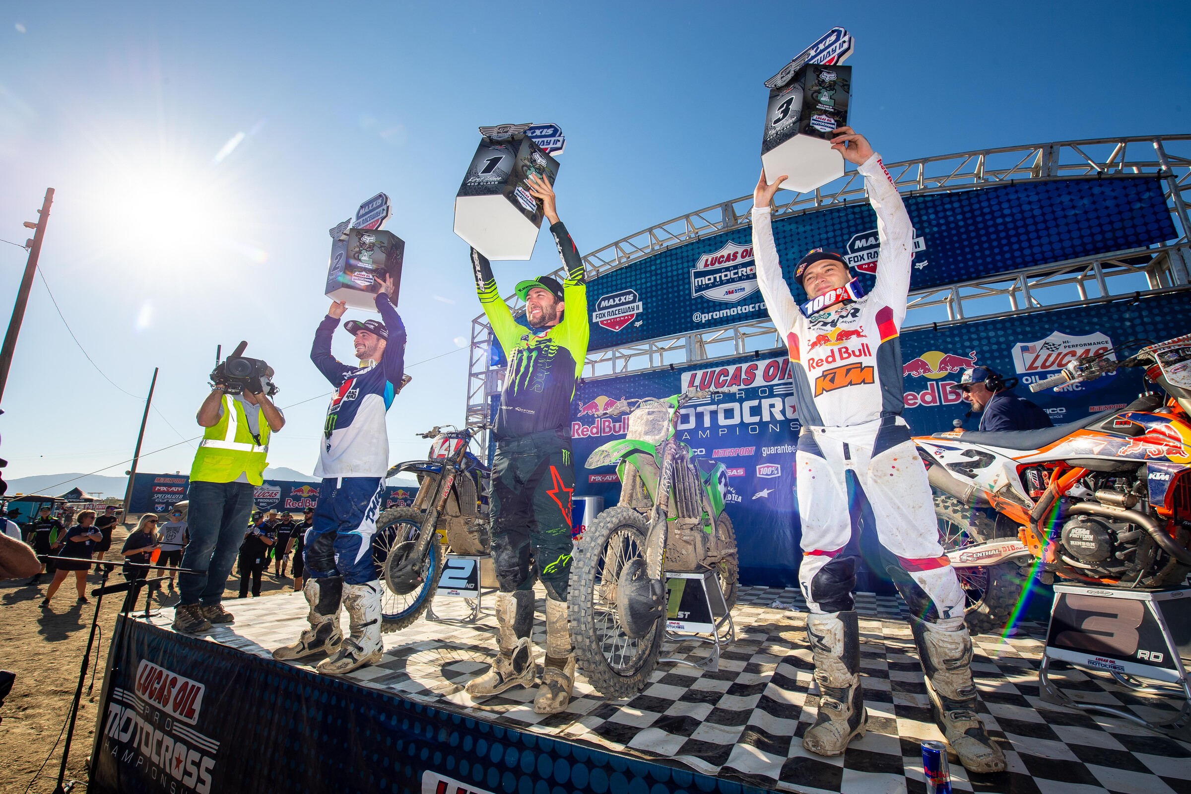 The 2021 Fox Raceway 2 National 450 Class overall podium: Eli Tomac (middle, 2-1 for first overall), Dylan Ferrandis (left, 1-2 for second overall), and Cooper Webb (right, 4-3 for third overall).