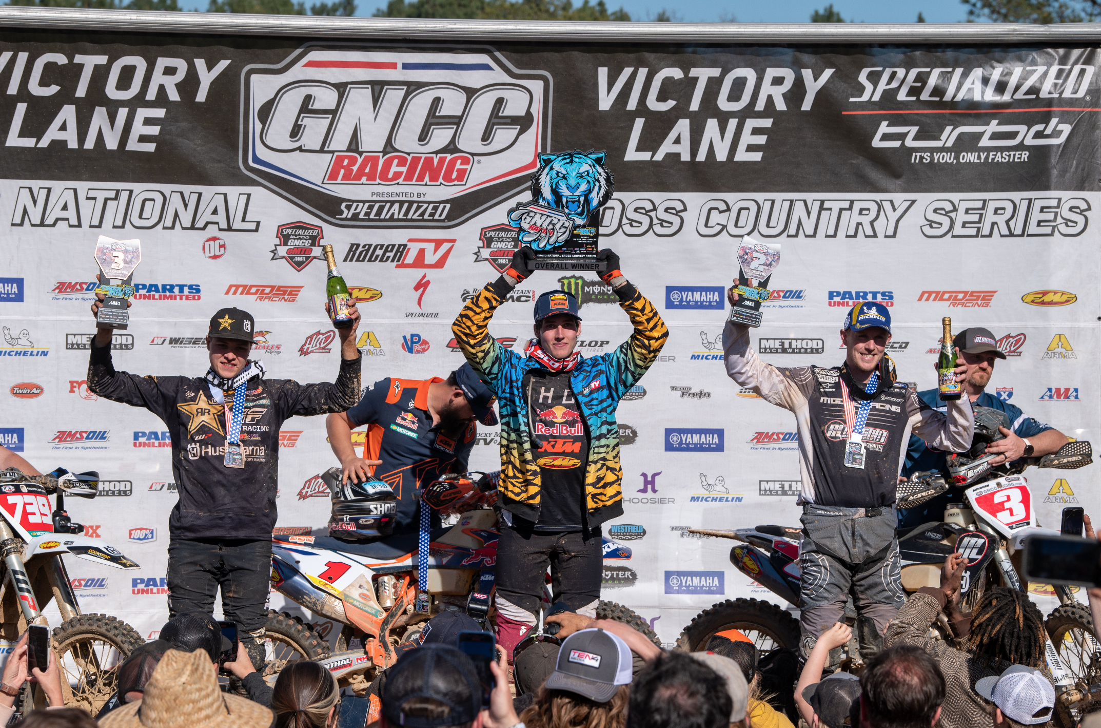 The Tiger Run GNCC overall podium: Ben Kelley (center, first place on KTM), Jordan Ashburn (right, second place on Husqvarna), and Trevor Bollinger (left, third place on Husqvarna).