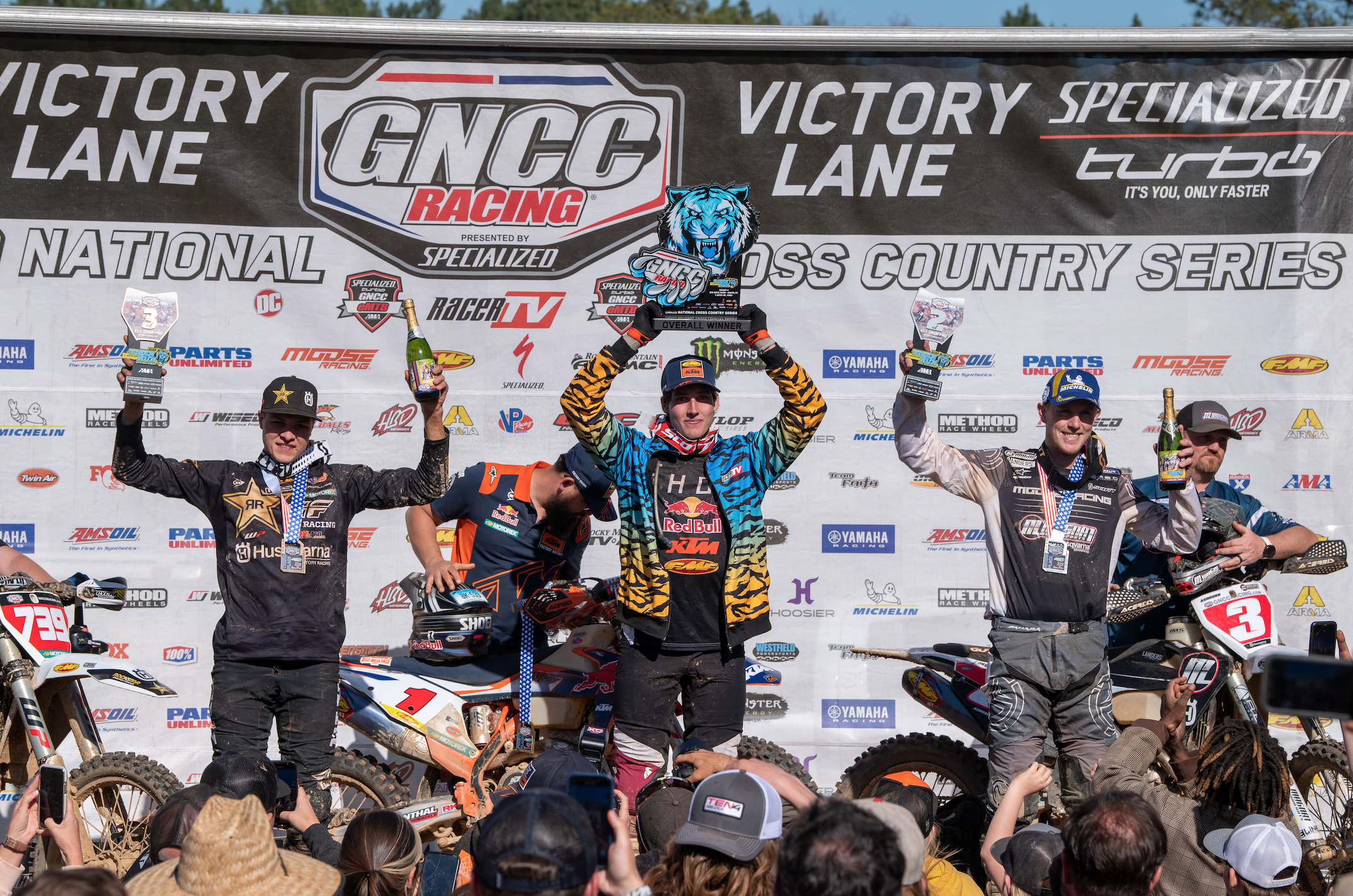 Ben Kelley (aka Joe Exotic) hoisting the Tiger Run GNCC overall trophy. Jordan Ashburn (right) and Trevor Bollinger (left) rounded out the overall podium.