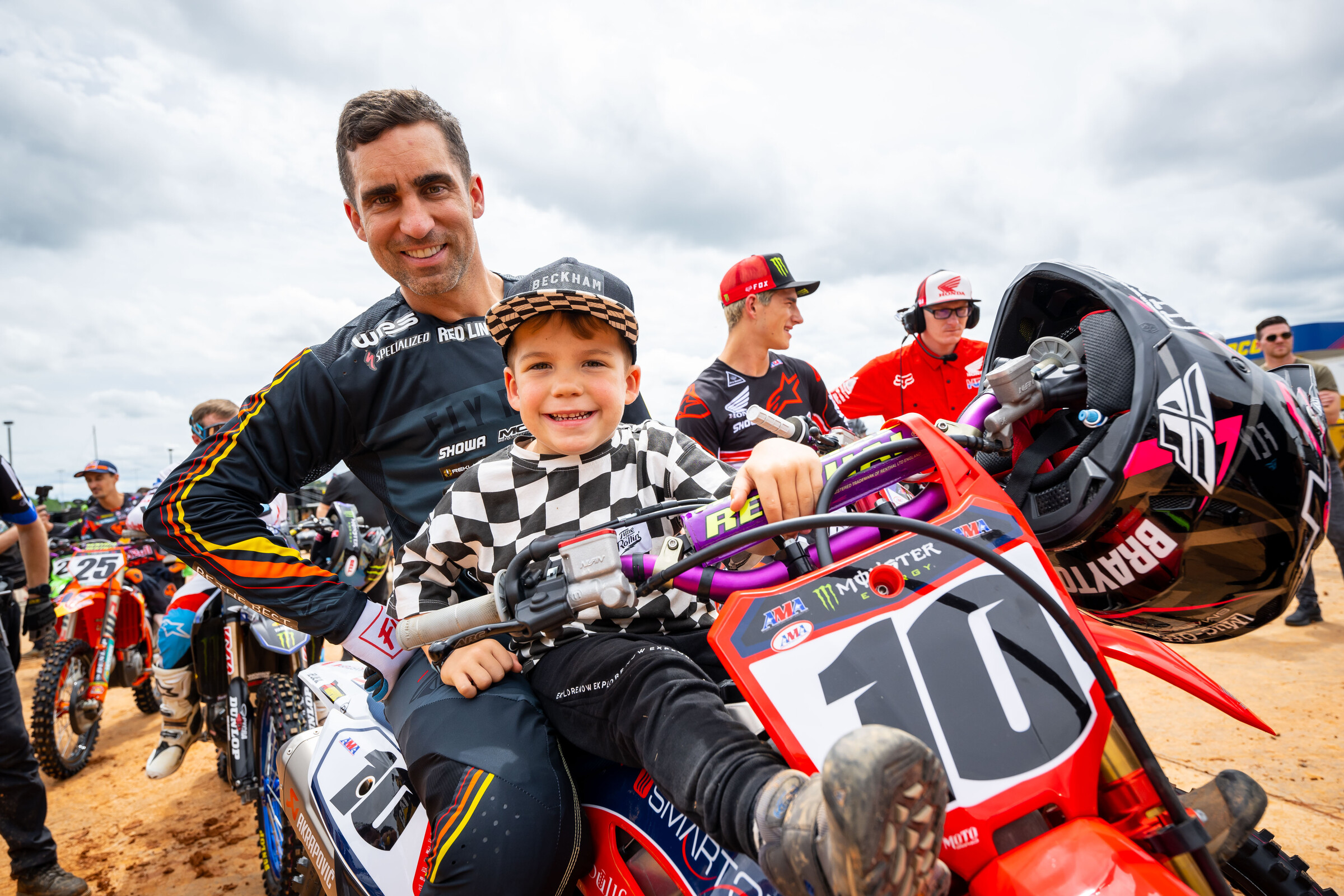 Justin Brayton and son Beckham wearing the checkered flag.