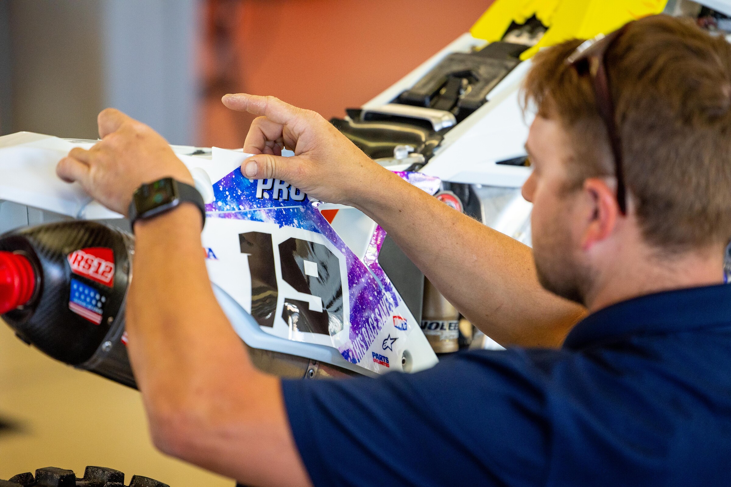 Careful installation of the HEP Motorsports graphics.