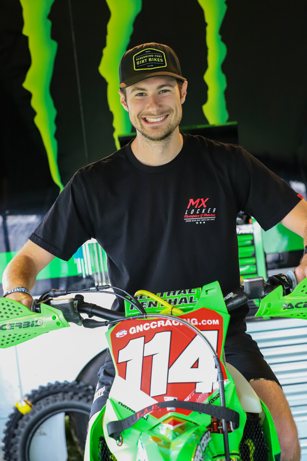 Mitch Kendra with Josh Strang's Kawasaki KX450X. Note the strap mounted the front of the bike. Muddy conditions led the Babbitt's team to prepare for the worst!
