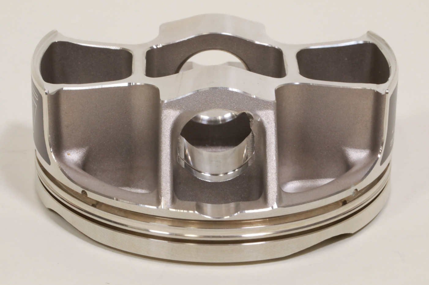 Updated piston skirt shape and ovality to improve operational stability and reduce frictional loss caused by cylinder wall contact, providing consistent ring seal and power and eliminating premature wear conditions.