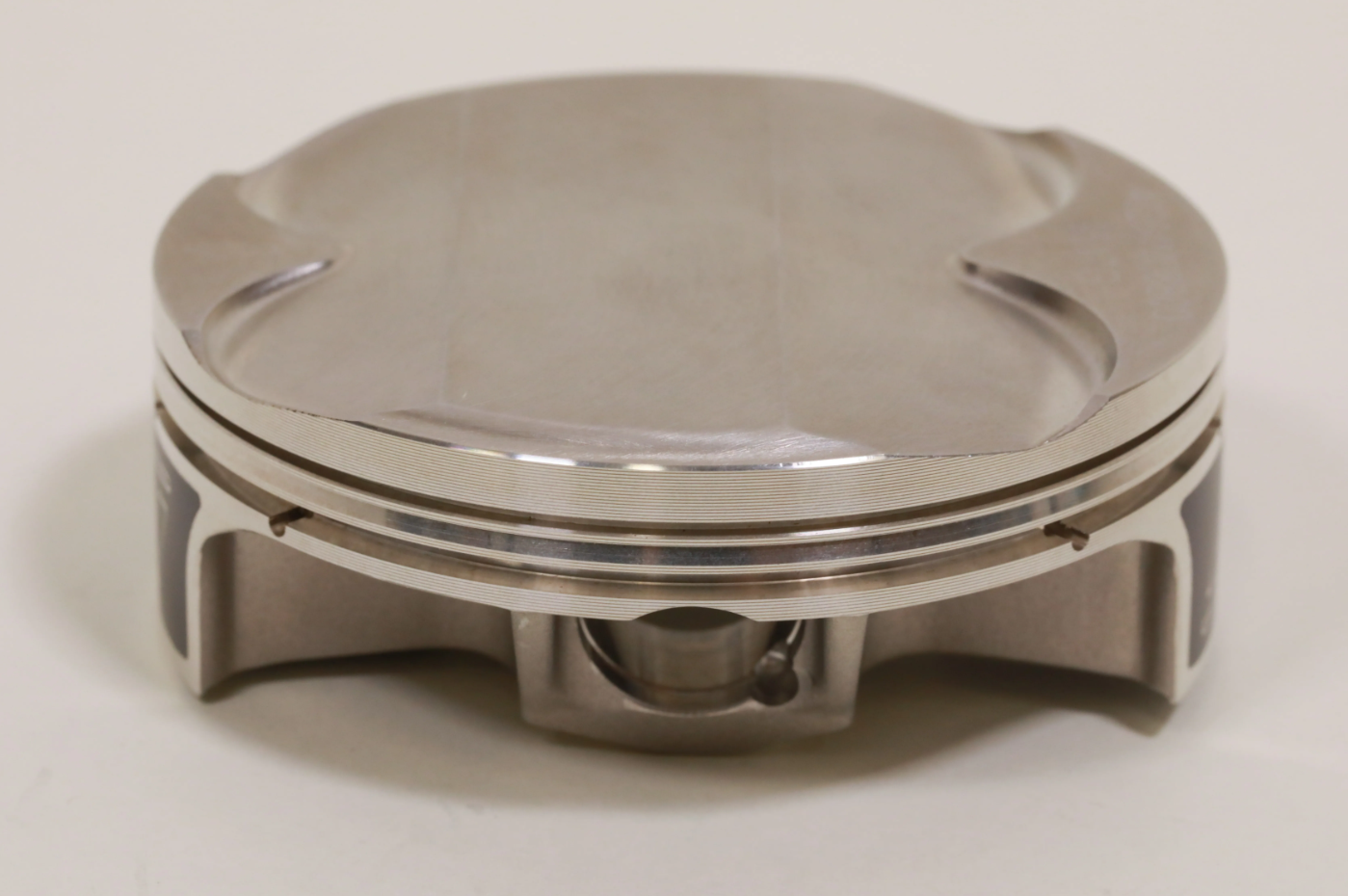 Updated piston skirt shape and ovality to improve operational stability and reduce frictional loss caused by cylinder wall contact, providing consistent ring seal and power and eliminating premature wear conditions.