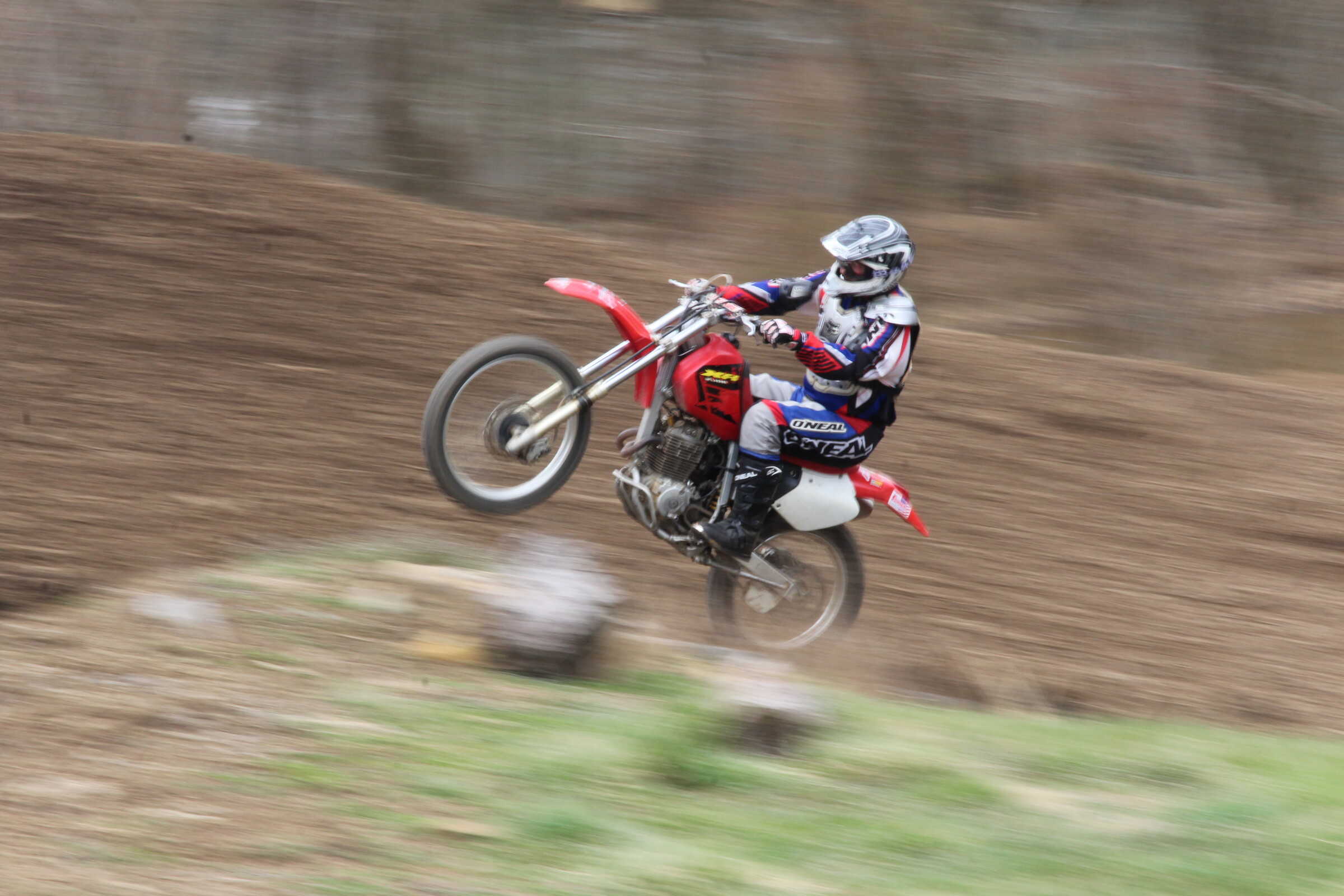 Mike Kendra pulling a wheelie in the same section of Creekside Motocross over 15 years later.