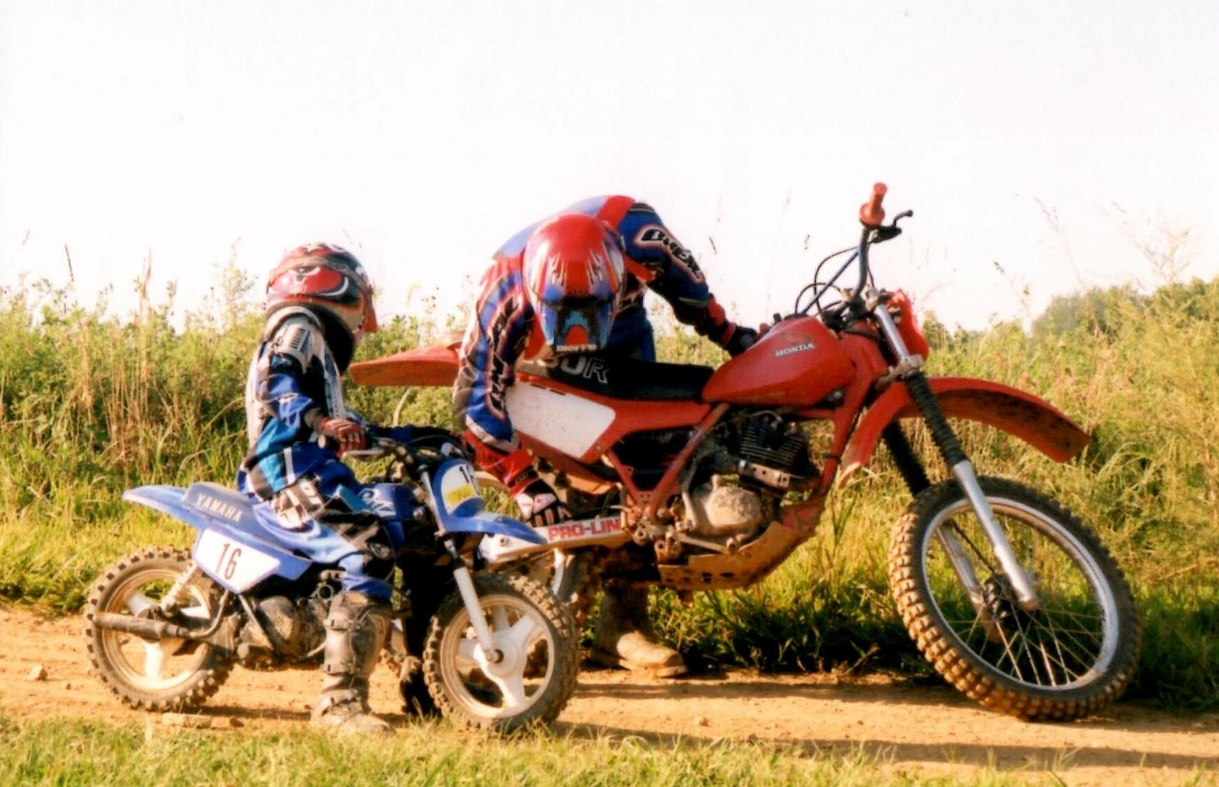 Mike is wondering what is wrong with his rear wheel. Mitch is also wondering what is wrong with his dad's wheel. This is one of Mike Kendra's favorite photos.
