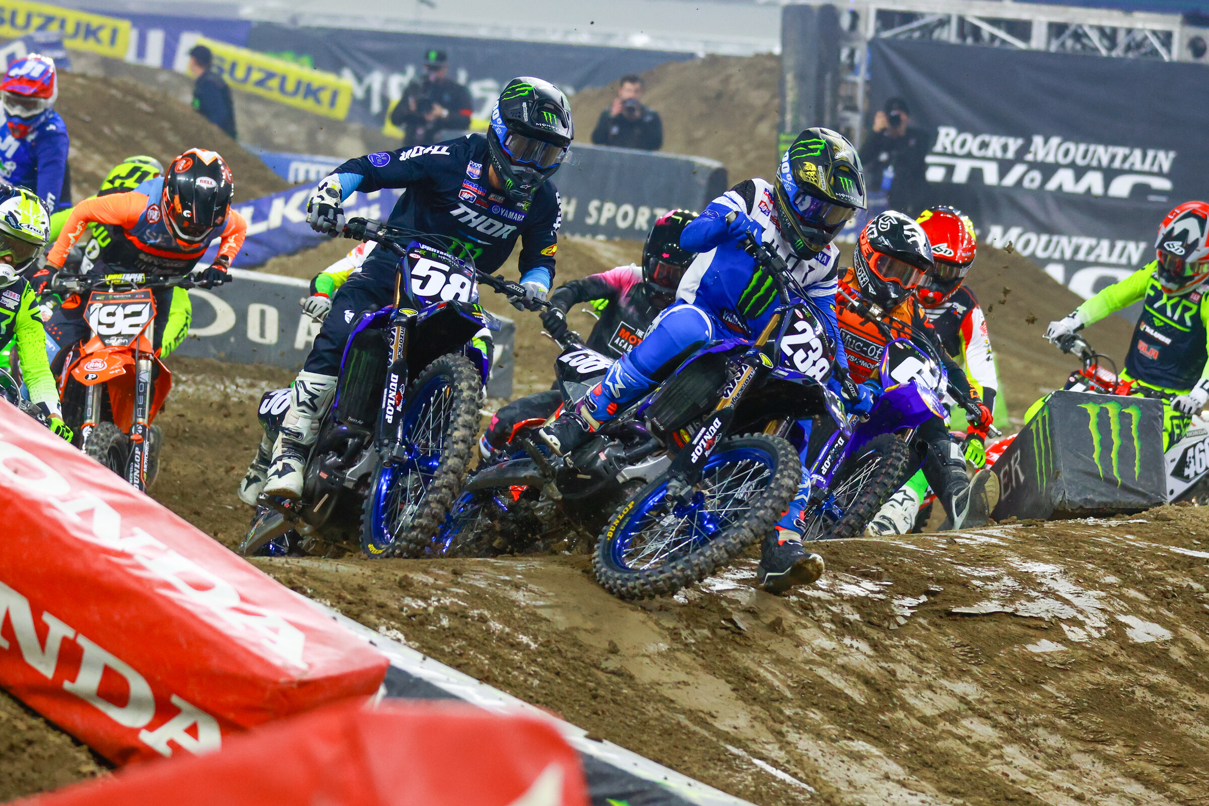 Haiden Deegan holeshotting the first 250SX heat race of the night, right next to his teammate Jordon Smith. The two would have a run in a few laps later.