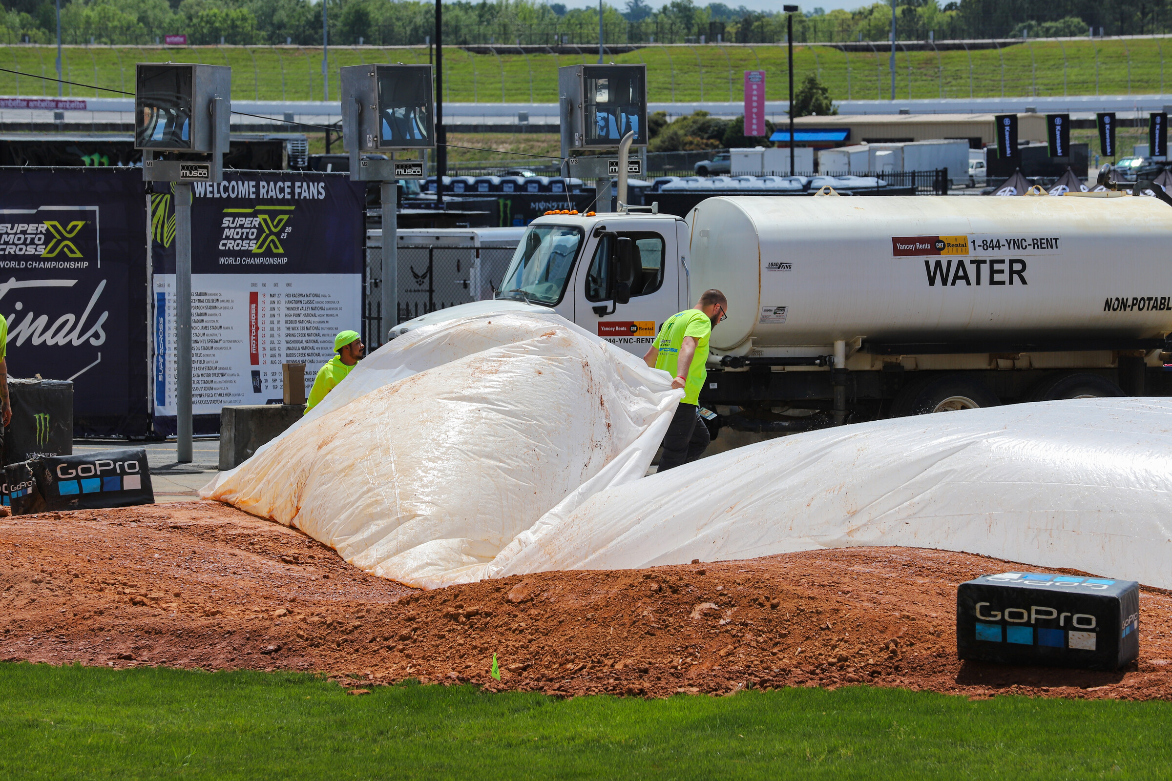 The Dirt Wurx crew taking the tarps off the track. About an hour later rain would come.