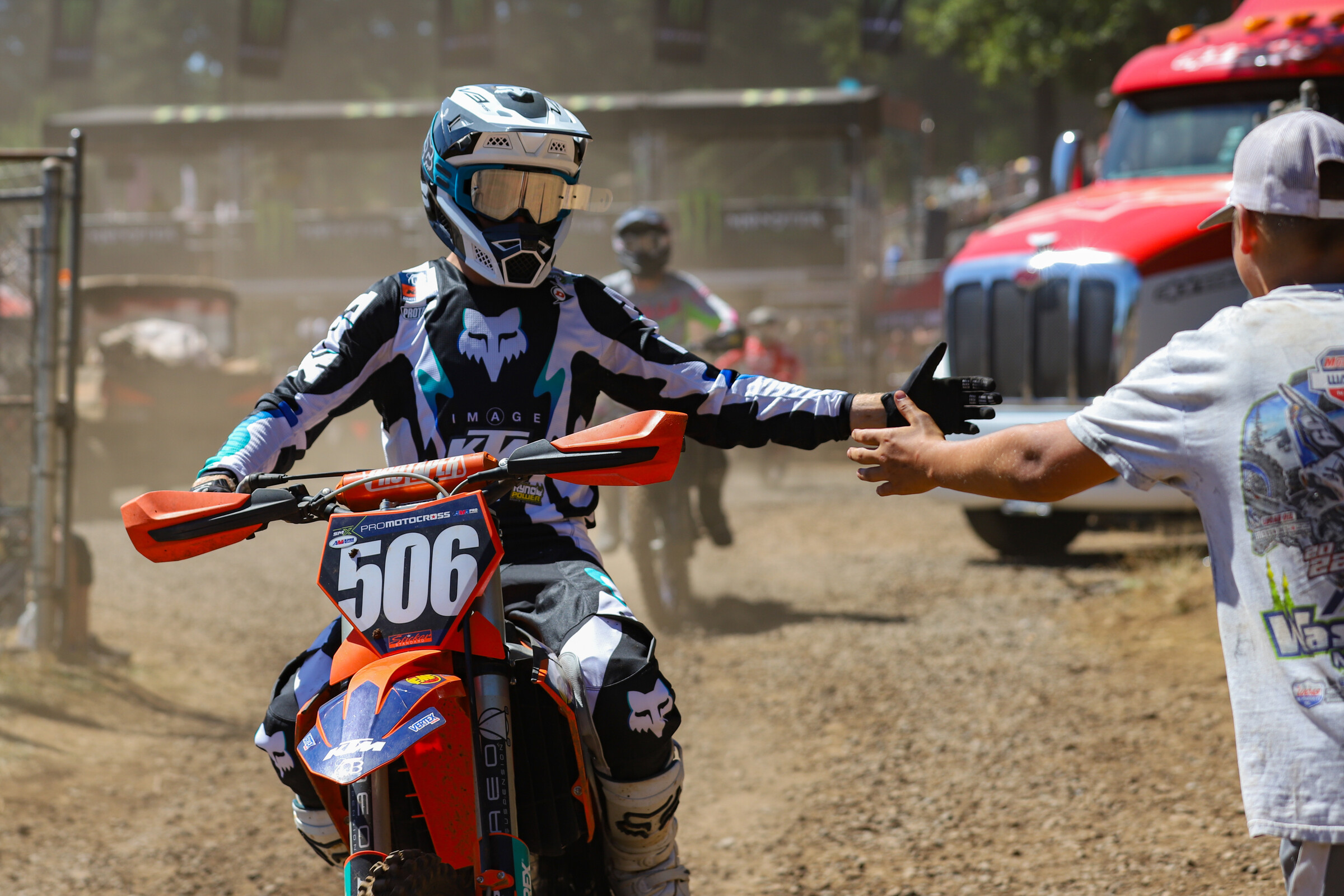 Preston Boespflug high fives a fan after returning for the site lap ahead of the second 250 Class moto.
