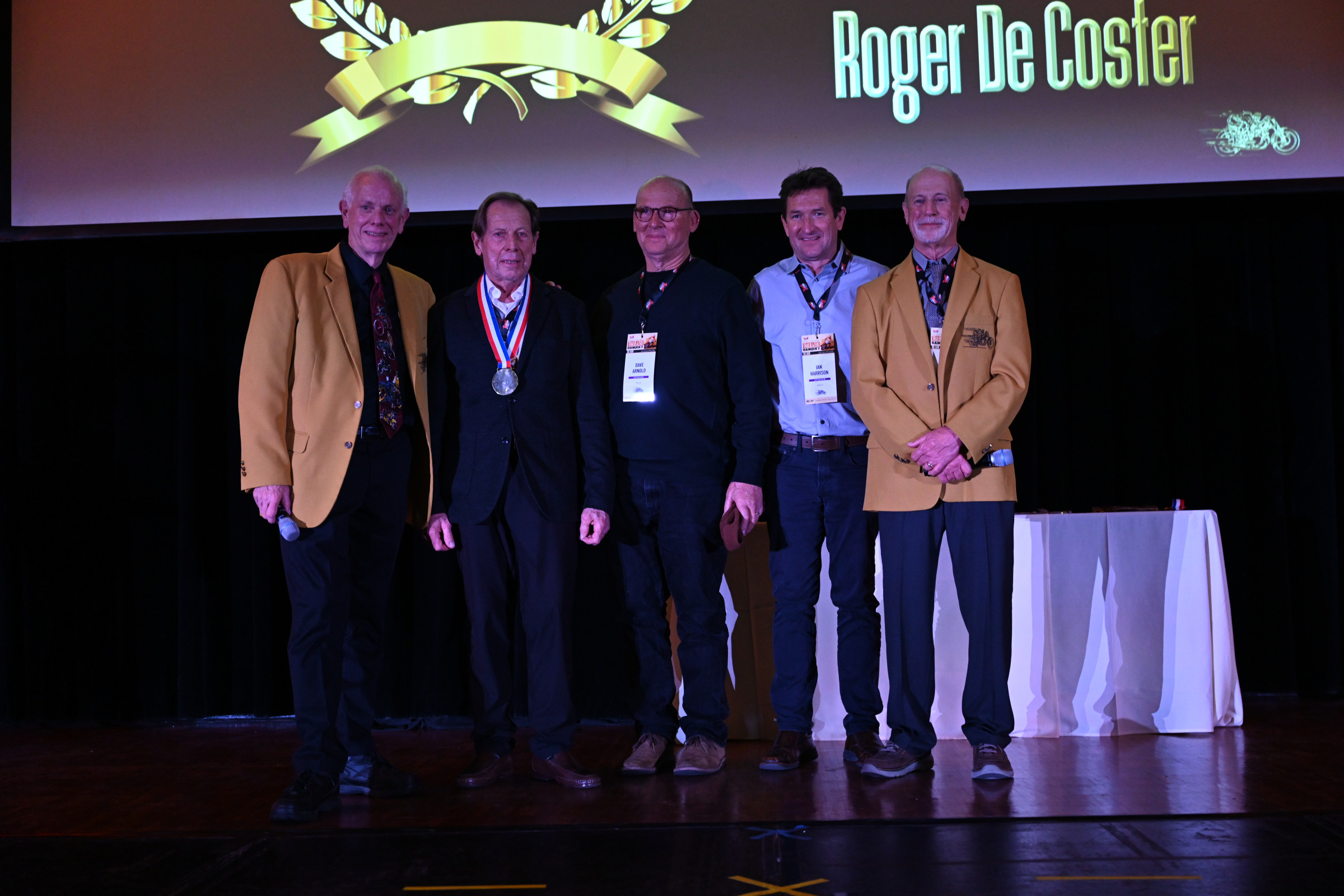 At Roger De Coster’s induction, he asked two valued associates he worked closely with during his career, Dave Arnold and Ian Harrison, to join him on stage. On the left is Trailblazers president Don Emde with Election Chairman Steve Storz on the right.