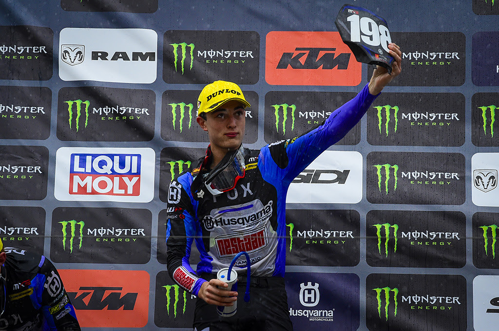 Below: Nice moment of fair-play and respect from Lucas Coenen on the podium of the Monster Energy MXGP of France as he holds the #198 plate high, showing support to Thibault Benistant after his injury sustained on Saturday. 