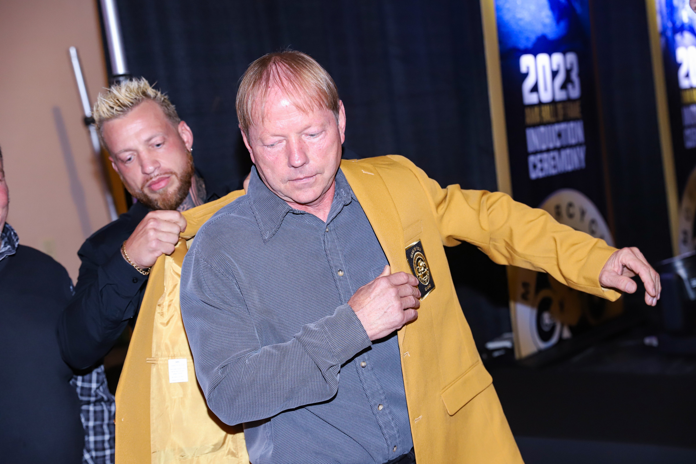Ed Lojak, with his son Eddie Lojak, Jr. putting on his AMA Hall of Fame gold jacket for the first time in fall 2023 at the Class of '23 induction ceremony.