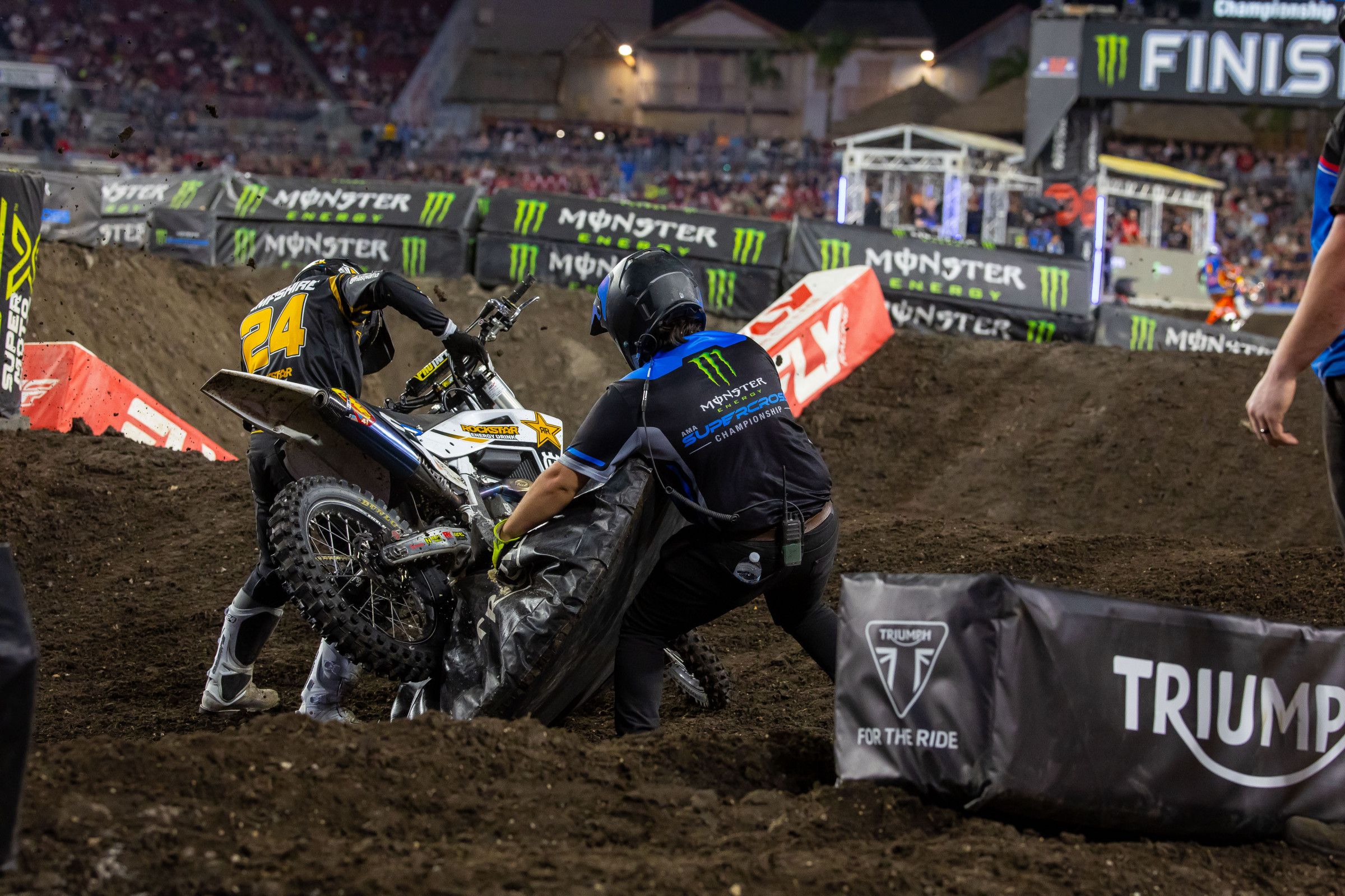 Hampshire and a track worker attempting to get his bike unstuck during the main event, which cost him a lot of time.
