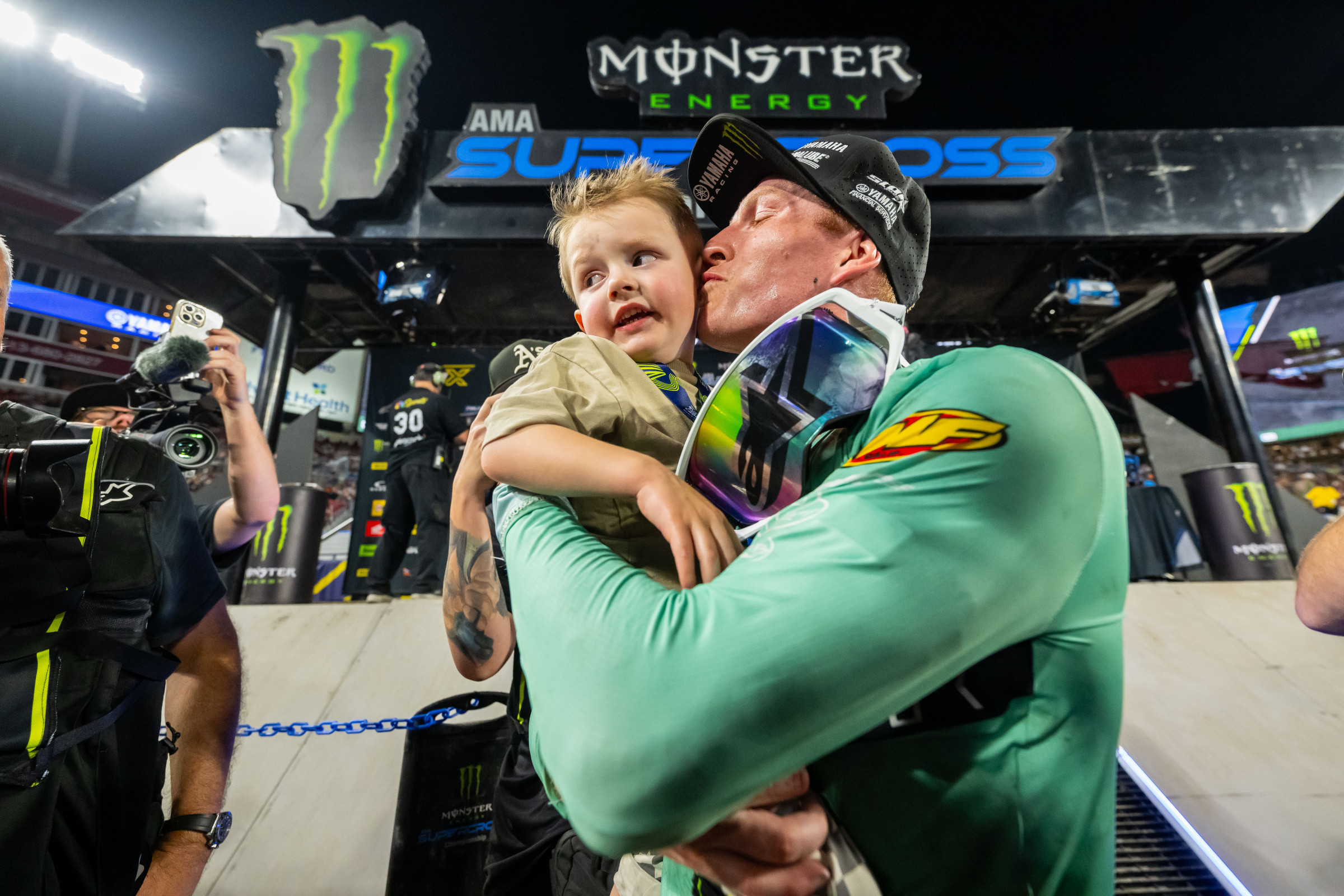 Anstie celebrates his win with his son. 
