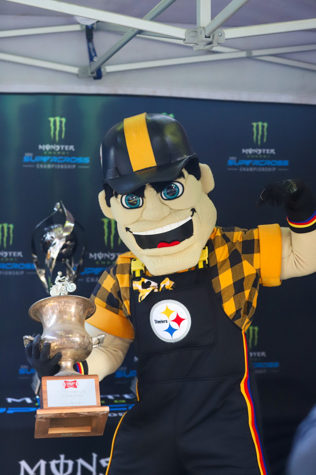 Steelers mascot Steely McBeam holds the 1983 Pittsburgh SX trophy.