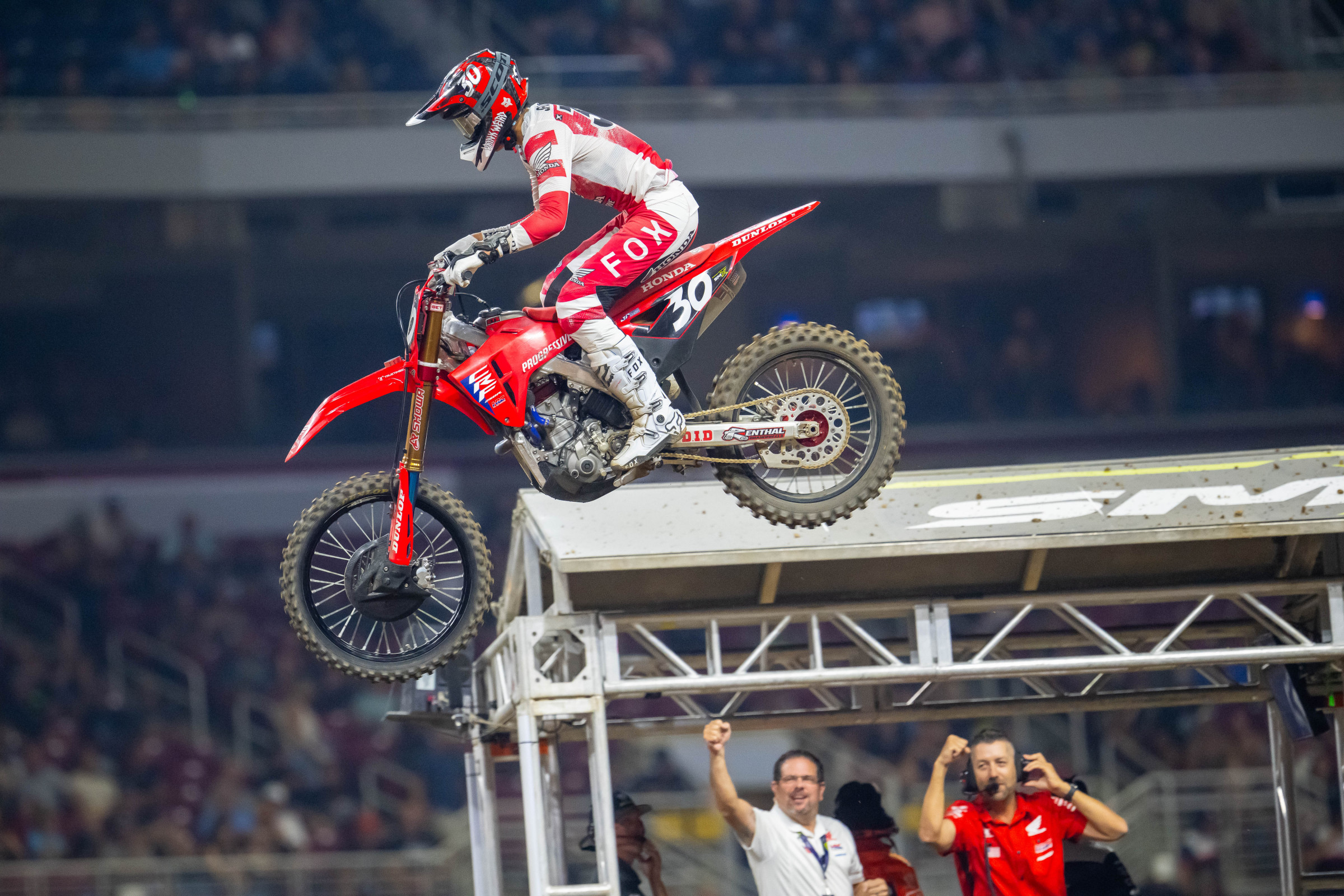 Shimoda comes through the checkered flag as Honda's Brandon Wilson and Lars Lindstrom cheer.