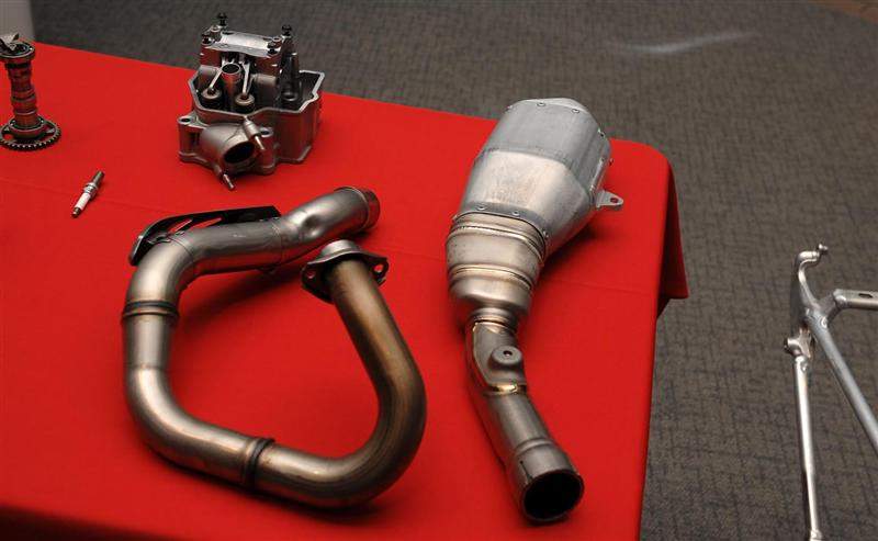 The exhaust header is now steel (to make it better for handling the rocks inevitably thrown up by the front wheel) while the muffler is now titanium to save weight.