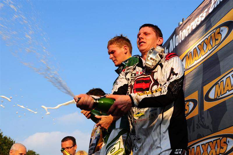The MX1 podium sprays champagne while the Maxxis girls (out of frame) run for cover.