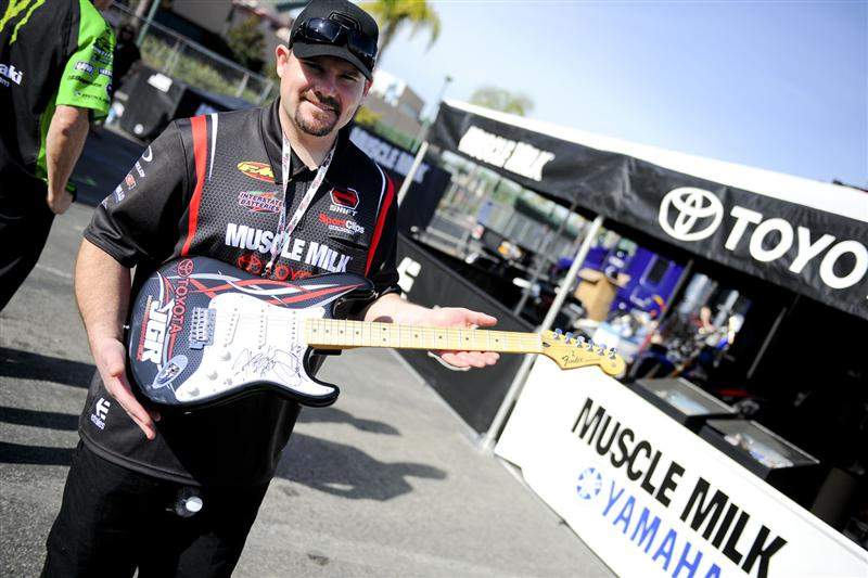 Coy Gibbs shows off the Fender Stratocaster they're giving away. It's signed by both Josh Grant and Justin Brayton.