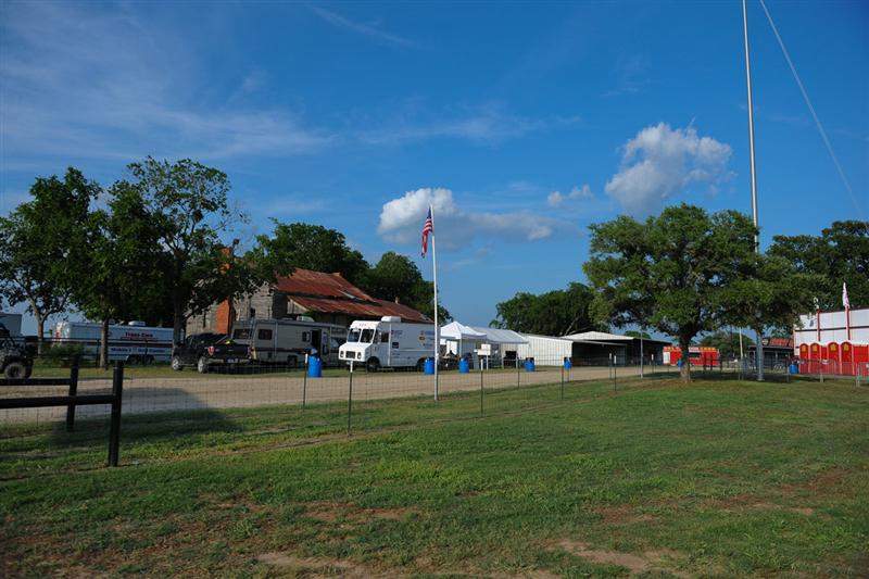 It's kind of cool to have a motocross race and an old, rusted house adjacent to one another, isn't it?
