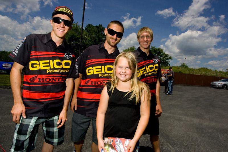 A lucky fan posed for a photo with the Geico Powersports Honda Team. 