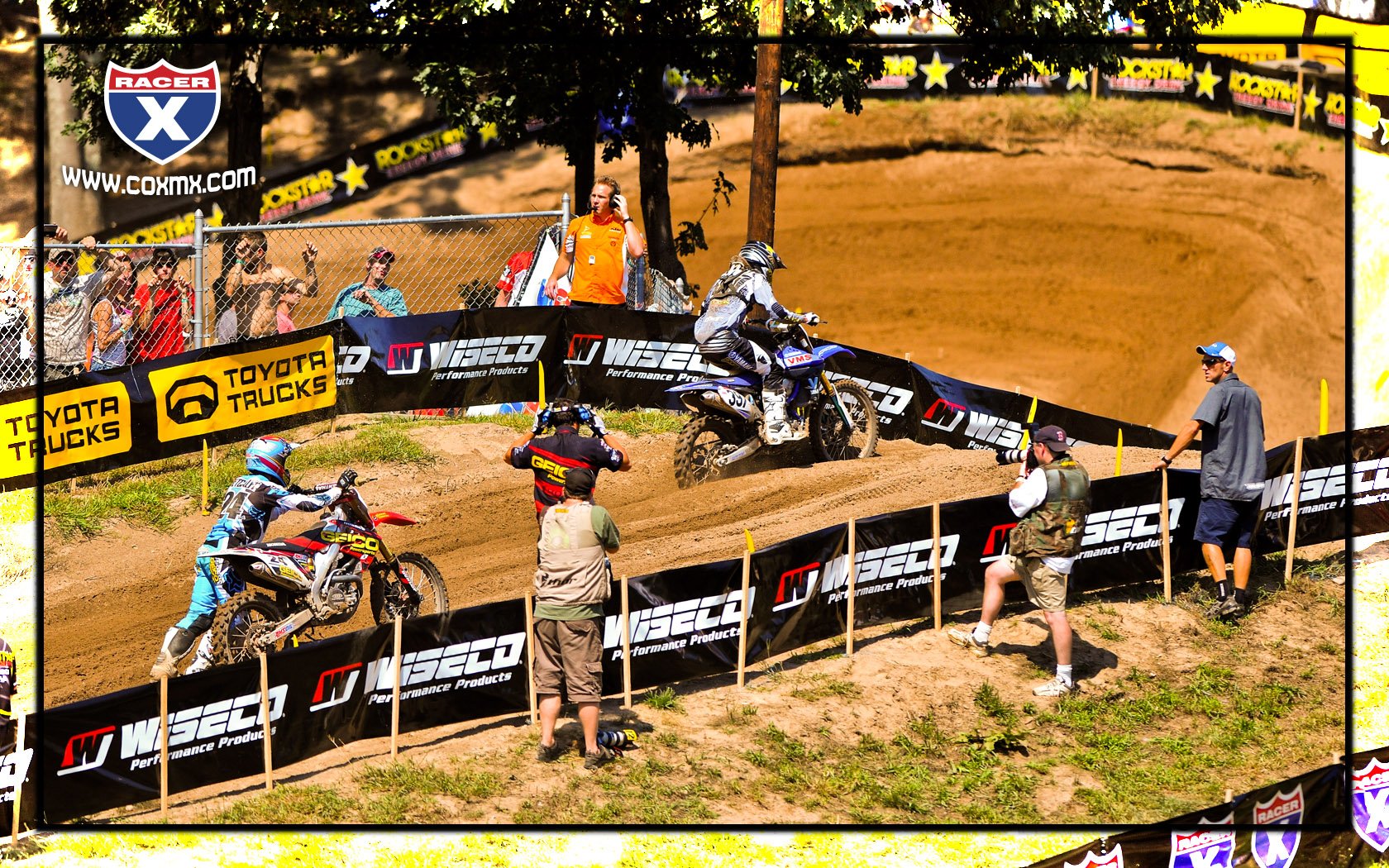 Brett Metcalfe pushes his bike up the hill after it ran out of gas in moto one.