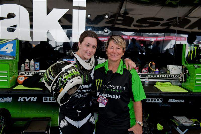 Sara Price (left) hangs with Kawi PR manager Jan Plessner (right) in the Kawasaki pits.