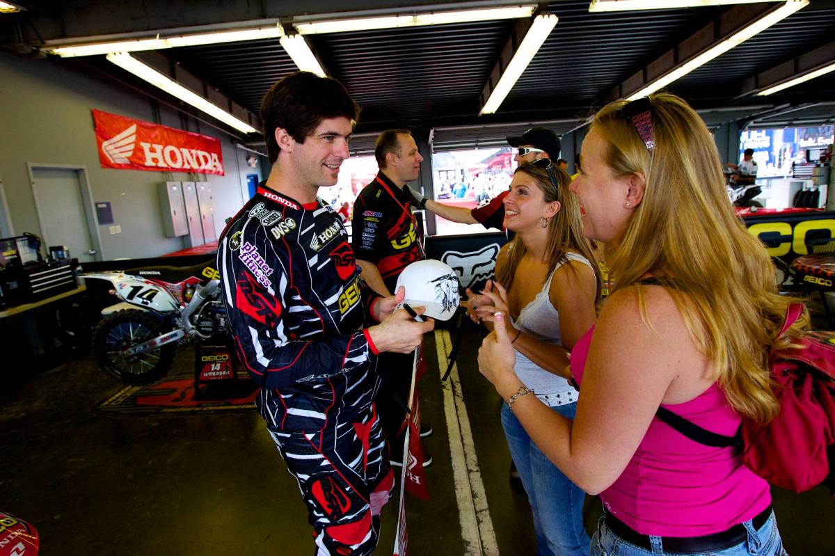 Kevin Windham gives an autograph to some happy fans