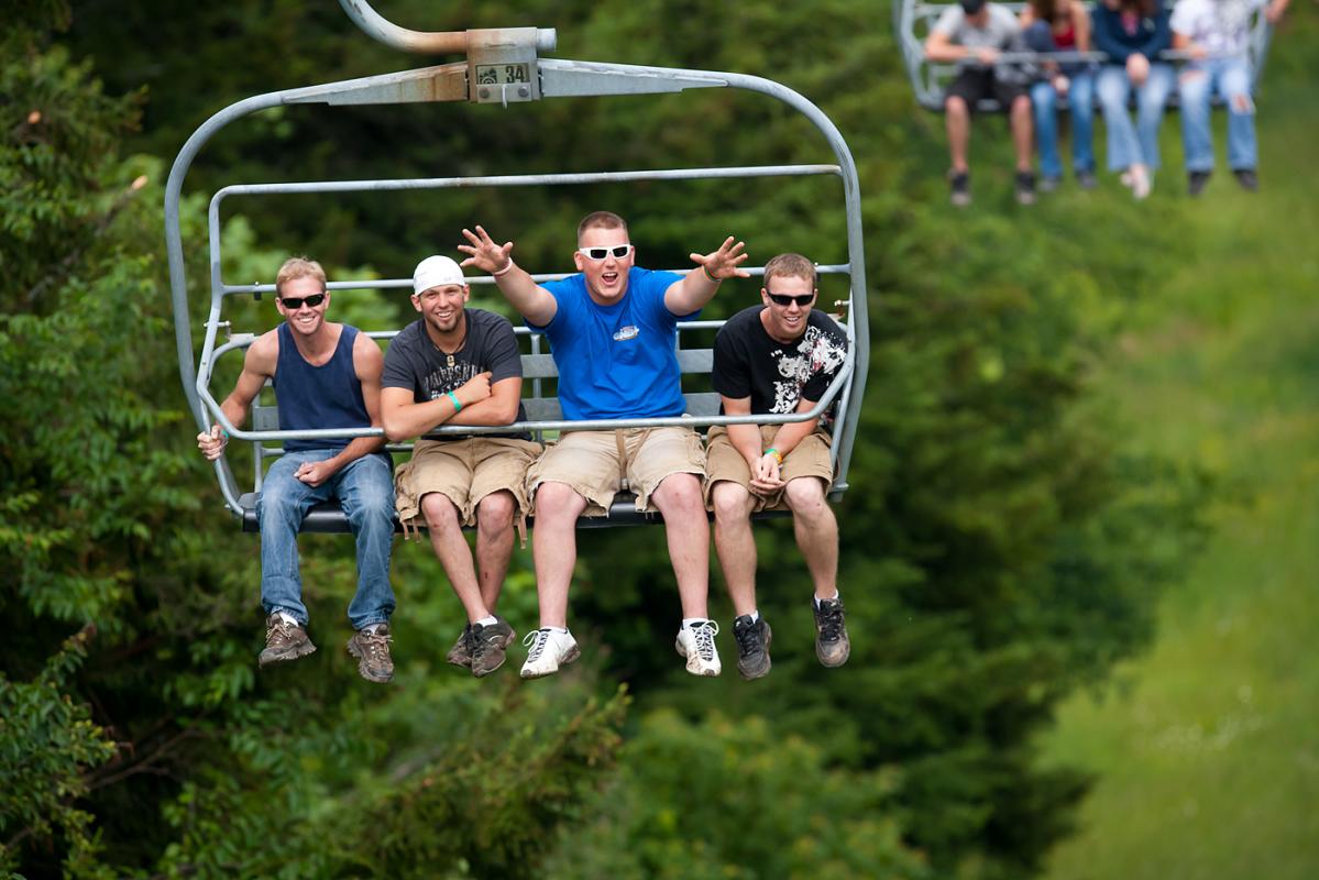 Fans ride the lift up and down the mountain to various spectator areas. Some are excited!