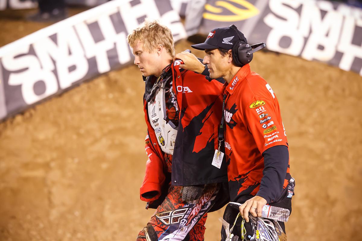 Short being helped off the track by Larry Brooks after a hard crash in San Diego
