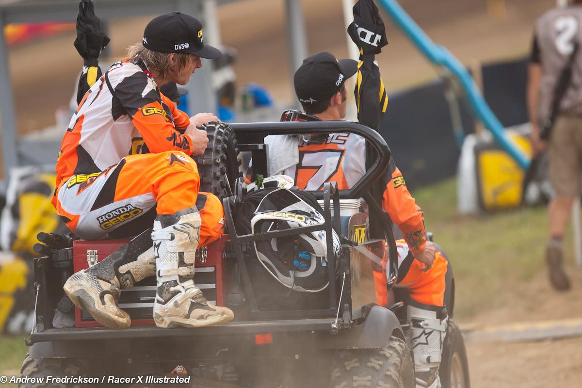 Barcia and Tomac hitch a ride back to the pits.