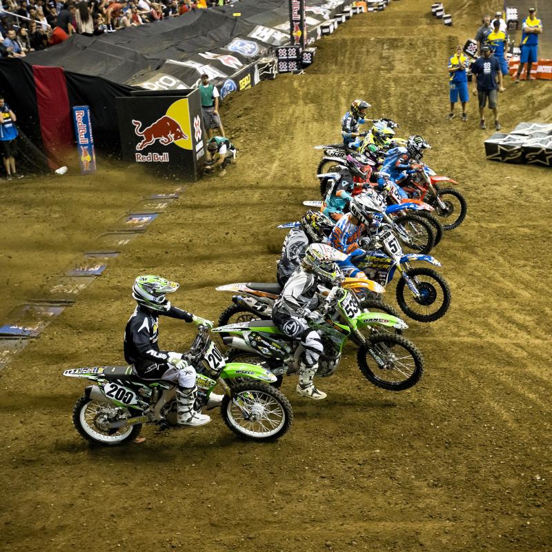 The pack heads down the start straight following the drop of the gate for the second Men’s qualifying heat.