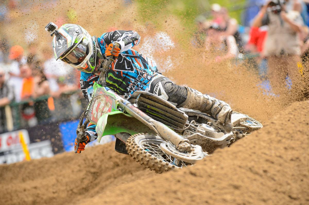 Ryan's making serious money by riding his bike through the pegs. He's standing slightly through this corner and forcing the KX to bite. Riding coaches have been marveling at Ryan's footwork, as he keeps his toes pointed in and on the peg. Check this out for reference. And look, we lost the back of the bike in the roost! 
