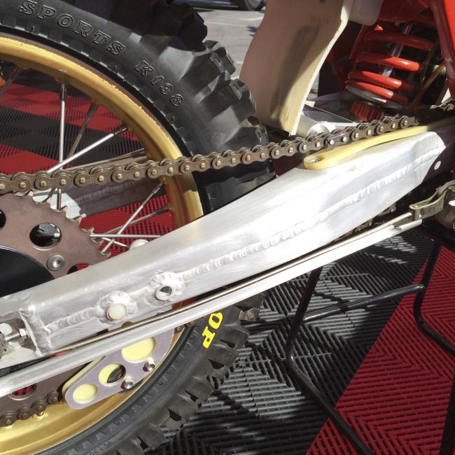 This swingarm is hand welded--note the additional tabs mounted throughout. These bikes changed constantly.