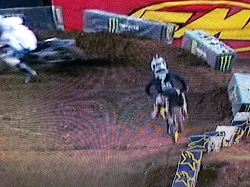 James is landing with his foot out, and the bike is already angling to turn in full attack position.