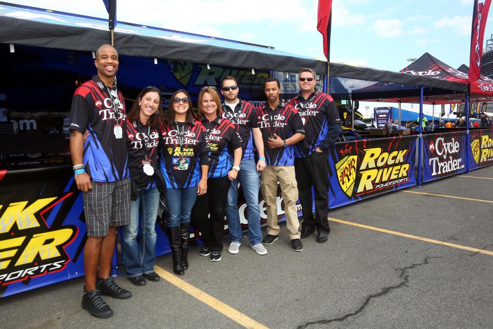 Denney (center) entertains the Cycle Trader.com contingent in her pits in East Rutherford.  