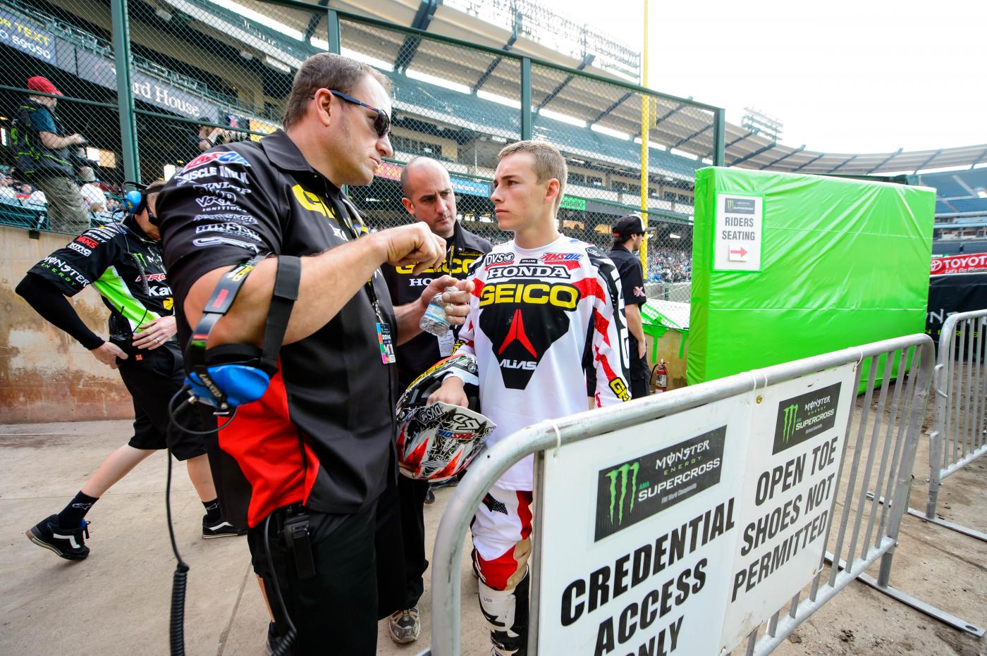 GEICO Honda's Mike LaRocco provides instruction for Zach Bell.