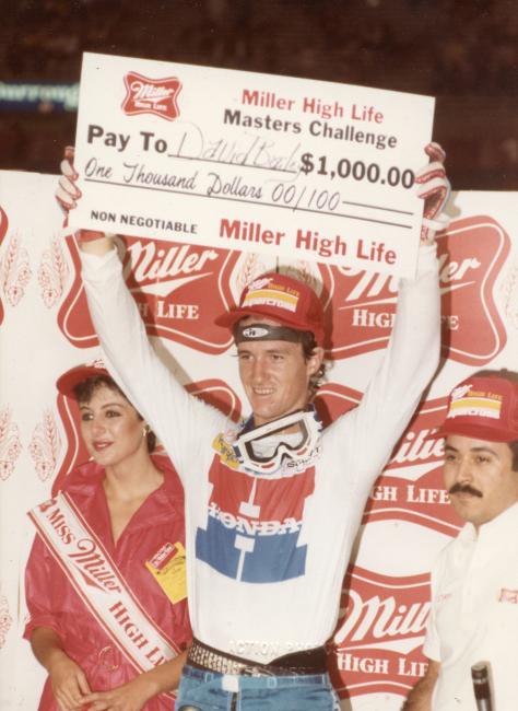 Defending champ David Bailey hoists one of his many bonus checks. 