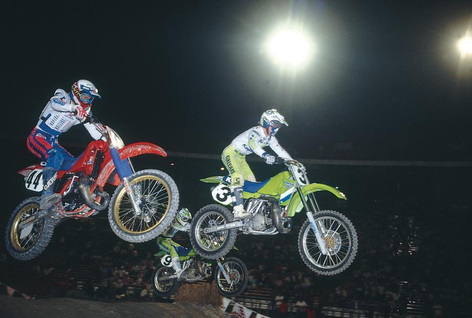 Jeff Ward (3) goes between privateer Fred Andrews (44) and his teammate Ron Lechien (9) on his march to the front. 