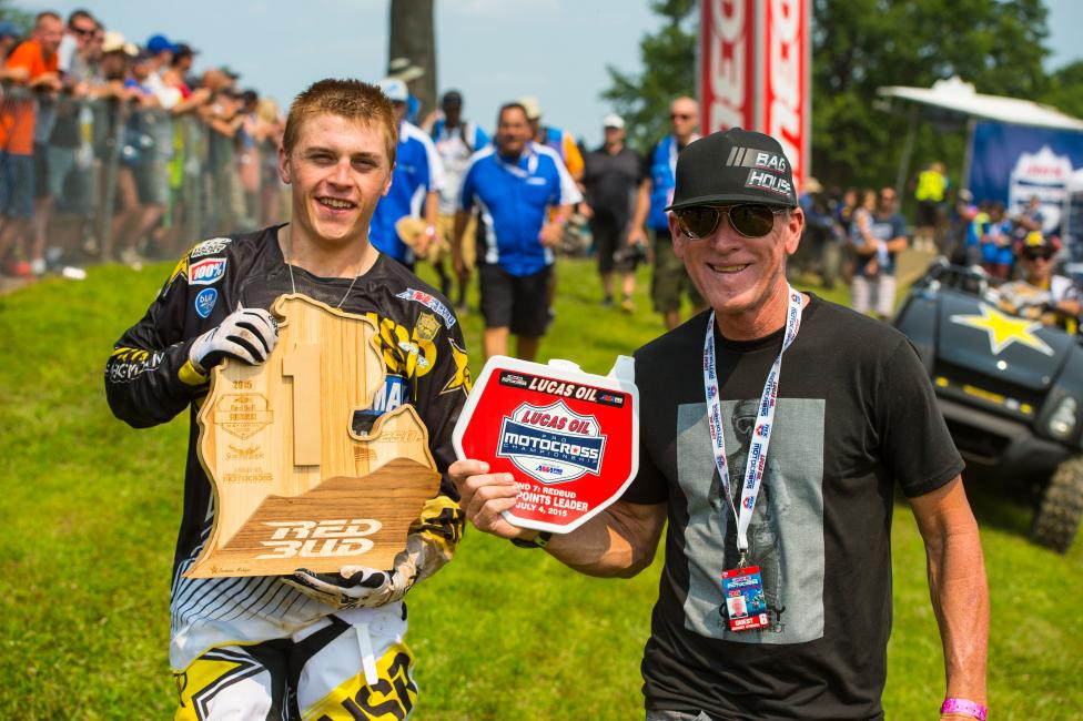 Sweet hand-carved RedBud trophy for J-Mart, standing next to his trainer Johnny O'Mara. The dark outline at the bottom of the trophy is a model of LaRocco's Leap.