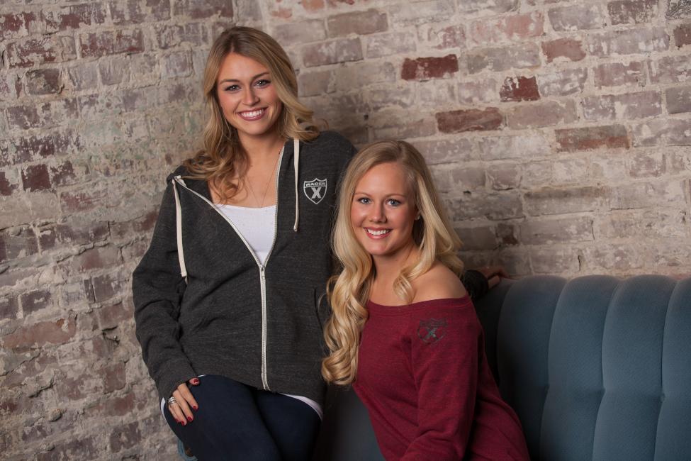 The zip-up shield hoodie is great for both guys and girls, and the women’s wide-neck sweater works on the shoulder as well as is does off.